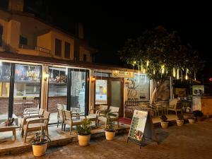 a patio with chairs and tables and a restaurant at night at Han Dalyan Hotel in Dalyan