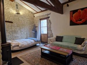 a living room with a couch and a table at La Grue Gites in Mons +55 photos