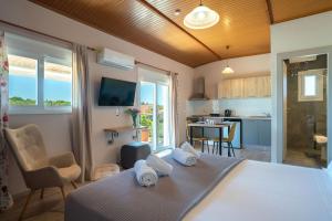 a bedroom with a bed and a living room with a kitchen at Siora Maria in Argostoli