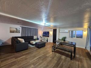 a living room with a couch and a table at Stargaze Grand Canyon in Meadview