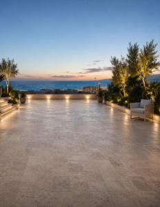 patio with a view of the city at night at Amare boutique Hotel in Salerno Airport - Aeroporto di Salerno