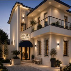a large white building with a bench in front of it at Amare boutique Hotel in Salerno Airport - Aeroporto di Salerno