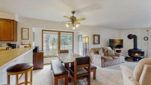 a kitchen and living room with a table and chairs at Lake Town Access Deck Pool Wood Stove in McCall