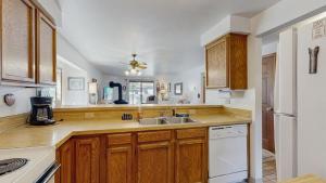a kitchen with wooden cabinets and a sink at Lake Town Access Deck Pool Wood Stove in McCall