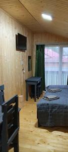 a bedroom with two beds and a table and a television at Садиба ВидНа in Kvasy +62 photos