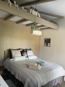 a bedroom with a large bed with towels on it at À l ombre des chênes in Moissac +31 photos
