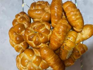 a pile of pretzels and croissants on a rack at Zhailoo Guest House Kochkor in Kochkorka