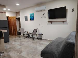 a living room with a flat screen tv on the wall at Depa Caribe III in Bacalar