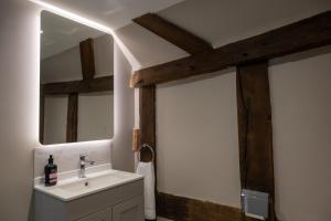 a bathroom with a sink and a mirror at Characterful Home Steps from Cathedral in Hereford +25 photos
