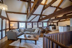 a living room with a couch and a table at Characterful Home Steps from Cathedral in Hereford