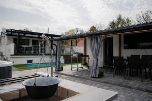 a patio with a tub on top of a house at Time to Relax in Zalakaros