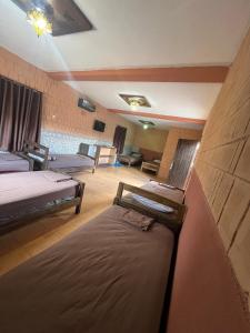 a room with two beds and a living room at LA GRANJA in Tétouan