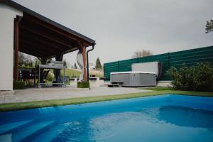 a swimming pool in front of a house with a gazebo at Time to Relax in Zalakaros