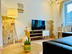 a living room with a tv and a table at Ferienwohnung Alpenpfad in Elmen