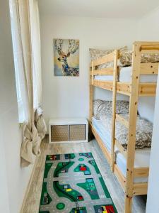 a bedroom with bunk beds and a toy train rug at Ferienwohnung Alpenpfad in Elmen