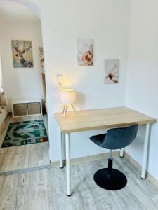a desk with a chair and a lamp in a room at Ferienwohnung Alpenpfad in Elmen +4 photos