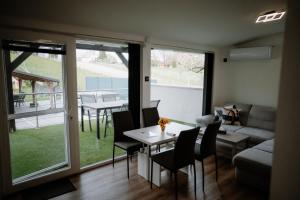 a living room with a table and chairs and a couch at Time to Relax in Zalakaros