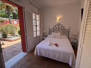 a bedroom with a bed with flowers on it at Hotel La Peña in Tarifa +56 photos