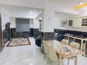 a kitchen with a table and chairs in a room at مضيف الزهراء in Karbala