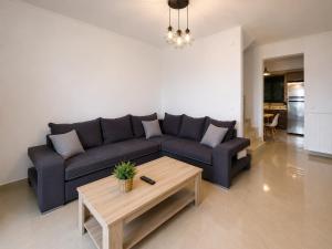 a living room with a couch and a coffee table at Zen Villas in Nikiana
