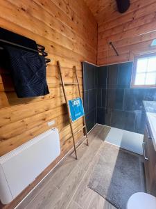 a small bathroom with a sign on the wall at Le cocon de La Bresse in La Bresse +14 photos