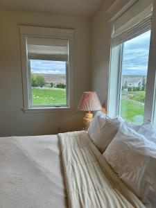 a bedroom with a white bed and a window at The Llama Lane House in Yakima