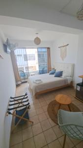 a bedroom with a bed and a table and chairs at VIVEMAR PUNTA HERMOSA - Beach House Lima - Perú in Punta Hermosa +77 photos