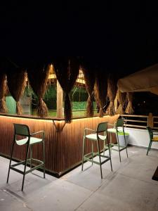 a group of chairs sitting on a patio at Bozcaada Su otel in Bozcaada