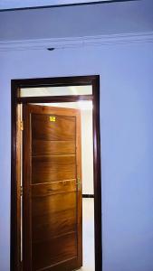 a wooden door in a room with a wall at Kithumulani Resort in Tiva