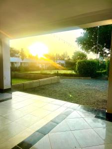 an open patio with the sun setting in the background at Kithumulani Resort in Tiva