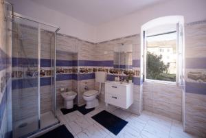 a bathroom with a toilet and a shower and a sink at zahira in Biassa +32 photos