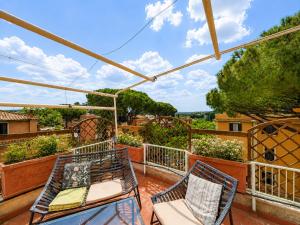 a balcony with two chairs and a table at PENTHOUSE LUXE - Rome in Rome