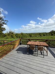 a wooden deck with a table and chairs on it at Celtic Glamping in Limerick