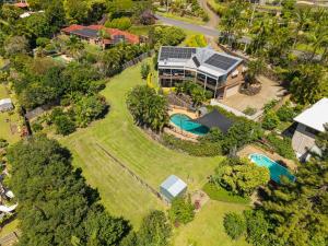 an aerial view of a house with a solar roof at King bed studio seperate entry sauna pool garden view in Terranora