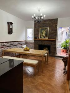 a living room with a table and a fireplace at Santo Domingo Rural - Andalusian spacious house with private parking in town in Archidona +19 photos