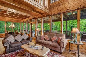 a living room with two couches and a table at Scenic Serenity #75 by Venture Smoky Mountains in Sevierville