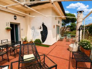 a patio with chairs and a painting on the wall at PENTHOUSE LUXE - Rome in Rome +9 photos