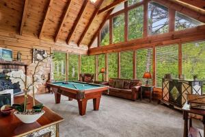 a living room with a pool table in a cabin at Scenic Serenity #75 by Venture Smoky Mountains in Sevierville