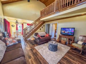 a living room with a couch and a tv at New: Charming and Cozy Great Value in Swanton