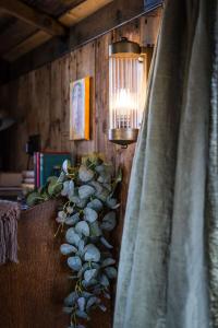 a table with a lamp and a plant on it at The 450 from Paddington in Bourton on Dunsmore
