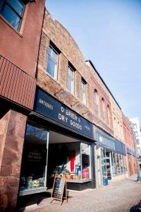 a store front of a brick building on a street at The Grey Cannon Guest House in Saint Cloud