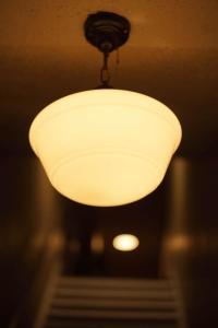 a light hanging from a ceiling in a room at The Grey Cannon Guest House in Saint Cloud