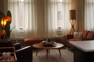 a living room with a couch and a table at The Grey Cannon Guest House in Saint Cloud