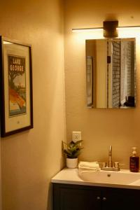 a bathroom with a sink and a mirror at The Grey Cannon Guest House in Saint Cloud +10 photos