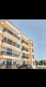 a large building with cars parked in front of it at Summer Malindi Family House in Malindi
