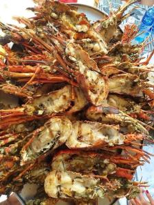 a pile of shrimp on a white plate at Summer Malindi Family House in Malindi