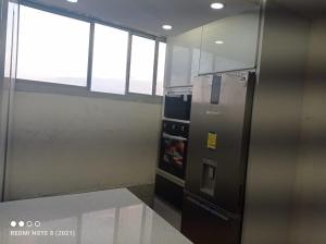 a kitchen with a stainless steel refrigerator in a room at Bloque 9y10 in Caracas