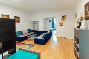 a living room with a blue couch and a table at City Center Studio in Graz