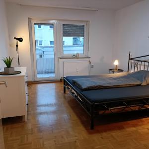 a bedroom with a bed and a large window at City-Quartier in Bad Mergentheim