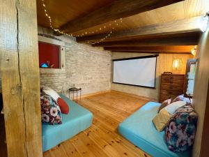 a room with two beds and a flat screen tv at Villa Violica, Karnevali in Žminj